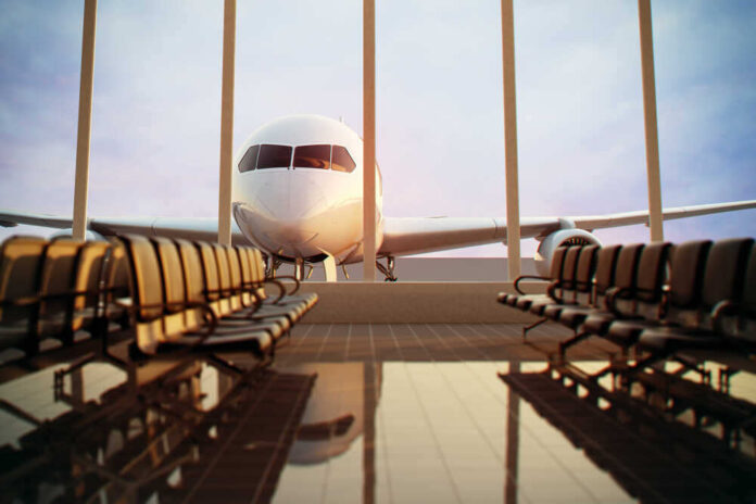shutterstock_124713472.jpg featured image Airplane viewed from an empty airport waiting area.