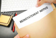 Reinstatement notice in envelope on office desk