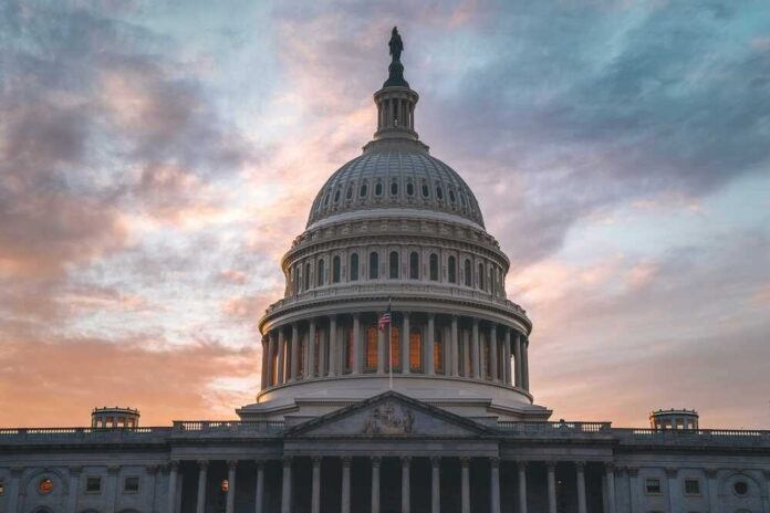 shutterstock_2470608247.jpg featured image US Capitol building at sunset with cloudy sky.