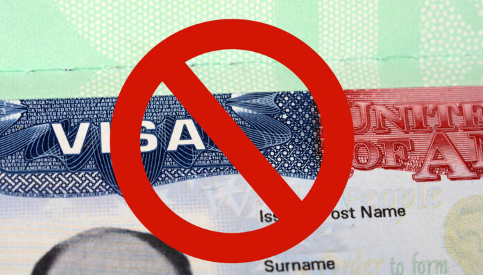 shutterstock_567543403.jpg featured image US visa with prohibition symbol overlay