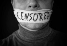 Mouth covered with censored cloth strip.