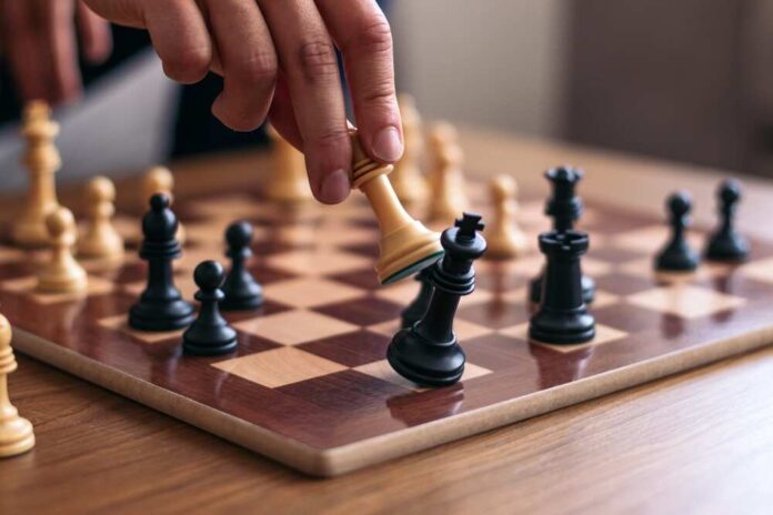 shutterstock_2461231653.jpg featured image Person playing chess wooden pieces on board