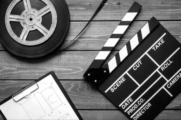 shutterstock_539523673-modified.jpg featured image Film reel, storyboard, and clapperboard on wooden surface.