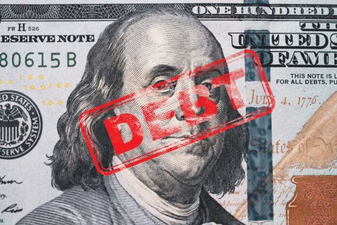 shutterstock_2407082349.jpg featured image Hundred dollar bill with red debt stamp