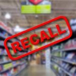 Blurred store aisle with RECALL stamp overlay.