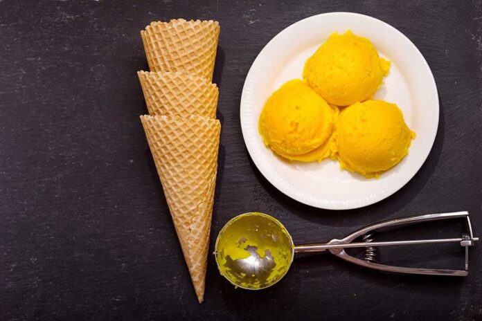 592796285 featured image Ice cream scoops, cones, and scoop tool on black background.