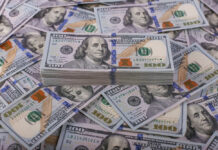 Stack of one hundred dollar bills, Benjamin Franklin's portrait.