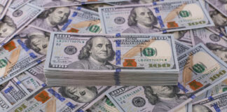Stack of one hundred dollar bills, Benjamin Franklin's portrait.