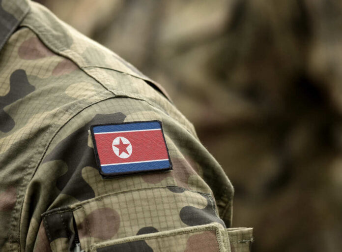 Camouflage uniform with North Korean flag patch.