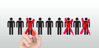 Hand crossing out stick figures with red marker