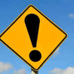 Trump Parade at Risk of Cancellation? Yellow caution sign with exclamation mark symbol.