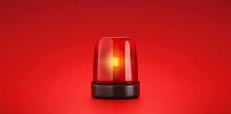 Red emergency light flashing on a red background.