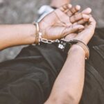 Dad Arrested – Baby Found Dead Person in handcuffs with hands behind back.