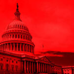 United States Capitol building under red-tinted sky.
