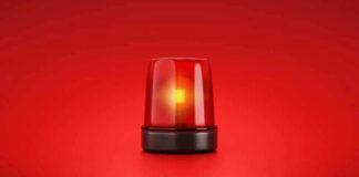 Red emergency light on solid red background