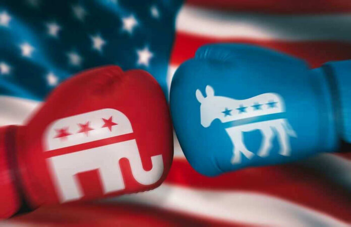 shutterstock_2220552921.jpg Red Republican glove and blue Democrat glove facing off
