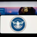 TSA logo on phone screen with website background