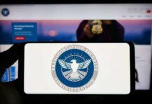 TSA logo on phone screen with website background