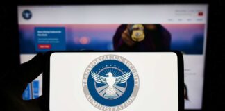 TSA logo on phone screen with website background