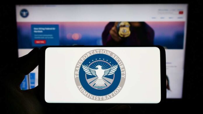 TSA logo on phone screen with website background