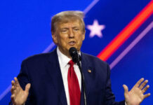 A man speaking at a podium with microphone