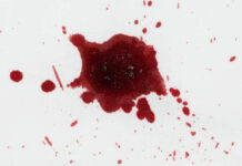 Red liquid splatter on a white background