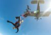 Skydivers jumping from an airplane in midair