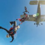 Skydivers jumping from an airplane in midair
