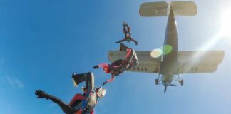 Skydivers jumping from an airplane in midair