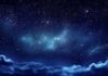 Starry night sky with clouds below