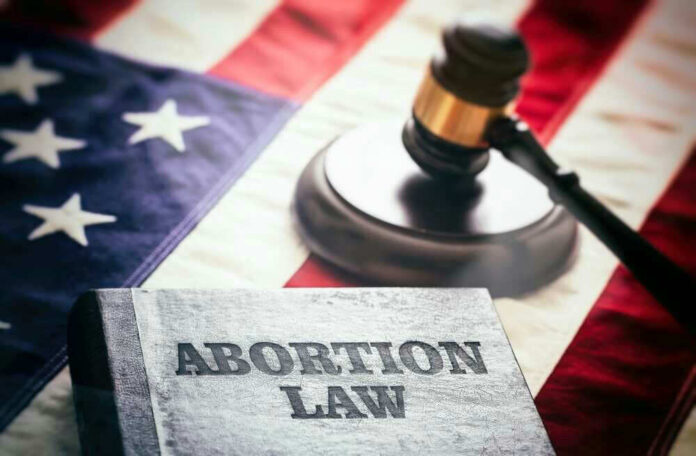 Book titled 'Abortion Law' with gavel and American flag