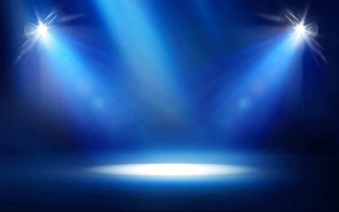 Empty stage with blue spotlights shining down