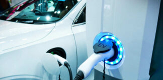 Electric vehicle charging at a station, close-up view