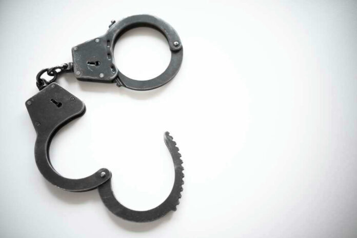 Open metal handcuffs on white background