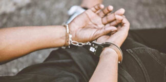Person in handcuffs with hands behind back
