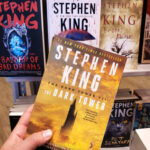 A person holding a Stephen King book