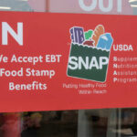 Red sign accepting EBT food stamp benefits SNAP
