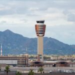 Airport control tower with mountains in the background