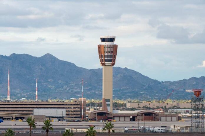Airport control tower with mountains in the background