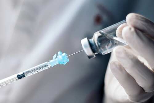 shutterstock_2452807617.jpg A healthcare professional preparing a syringe from a vial