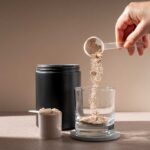 HORRIFYING Discovery: Protein Powders Poisoning Americans Hand scooping protein powder into a glass