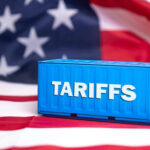 Shocker: Consumers Crushed by Tariffs Shipping container reading tariffs on the American flag