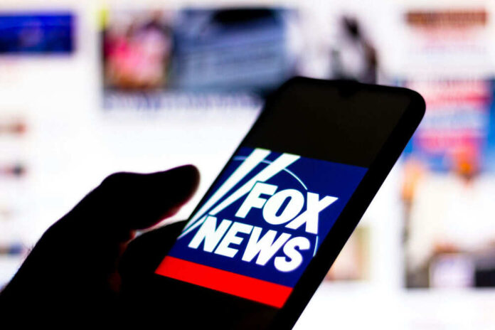Smartphone showing Fox News logo on screen