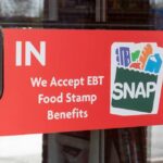 Sign on a store door indicating acceptance of EBT food stamp benefits