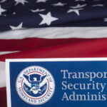 Transportation Security Administration sign in front of an American flag