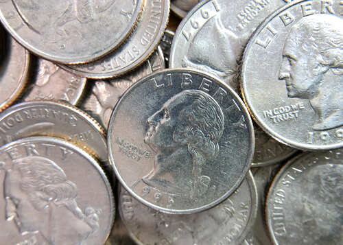 A close-up view of a pile of quarters