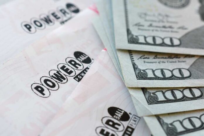 Powerball lottery tickets next to stacks of hundred dollar bills