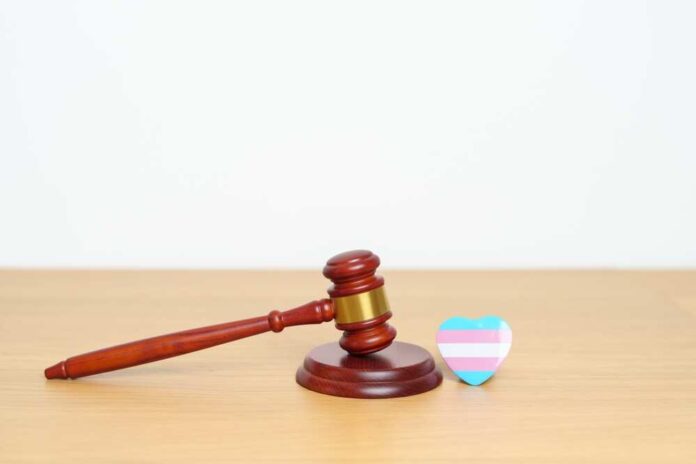 A wooden gavel next to a heart-shaped pride symbol