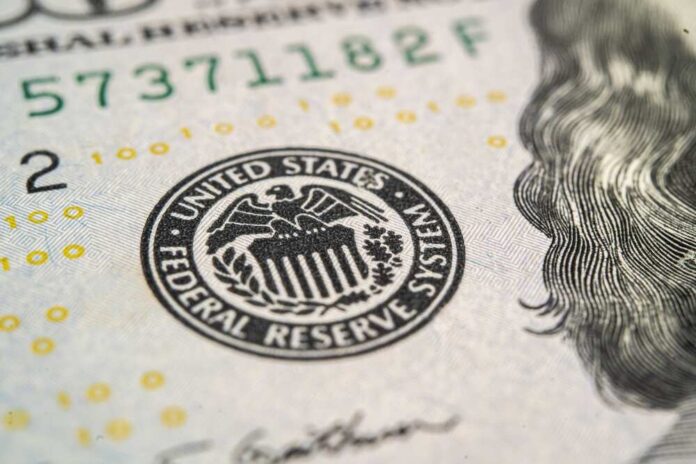 Close-up of a United States dollar bill featuring the Federal Reserve emblem