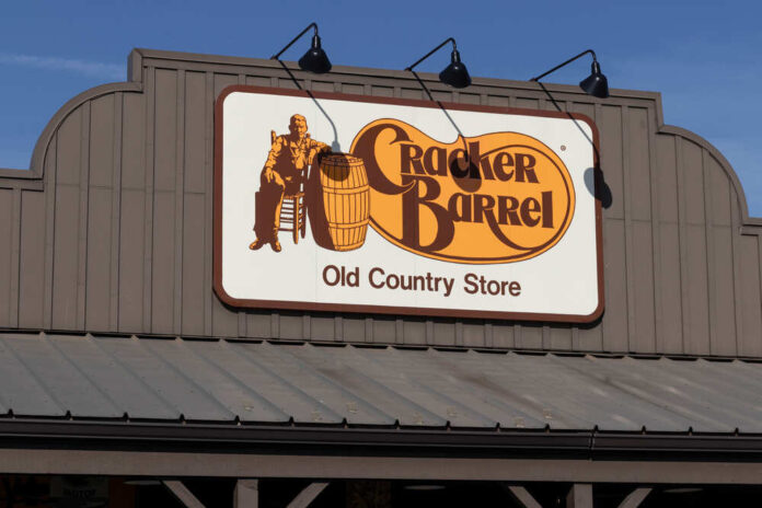 Sign for Cracker Barrel Old Country Store featuring a man sitting on a barrel